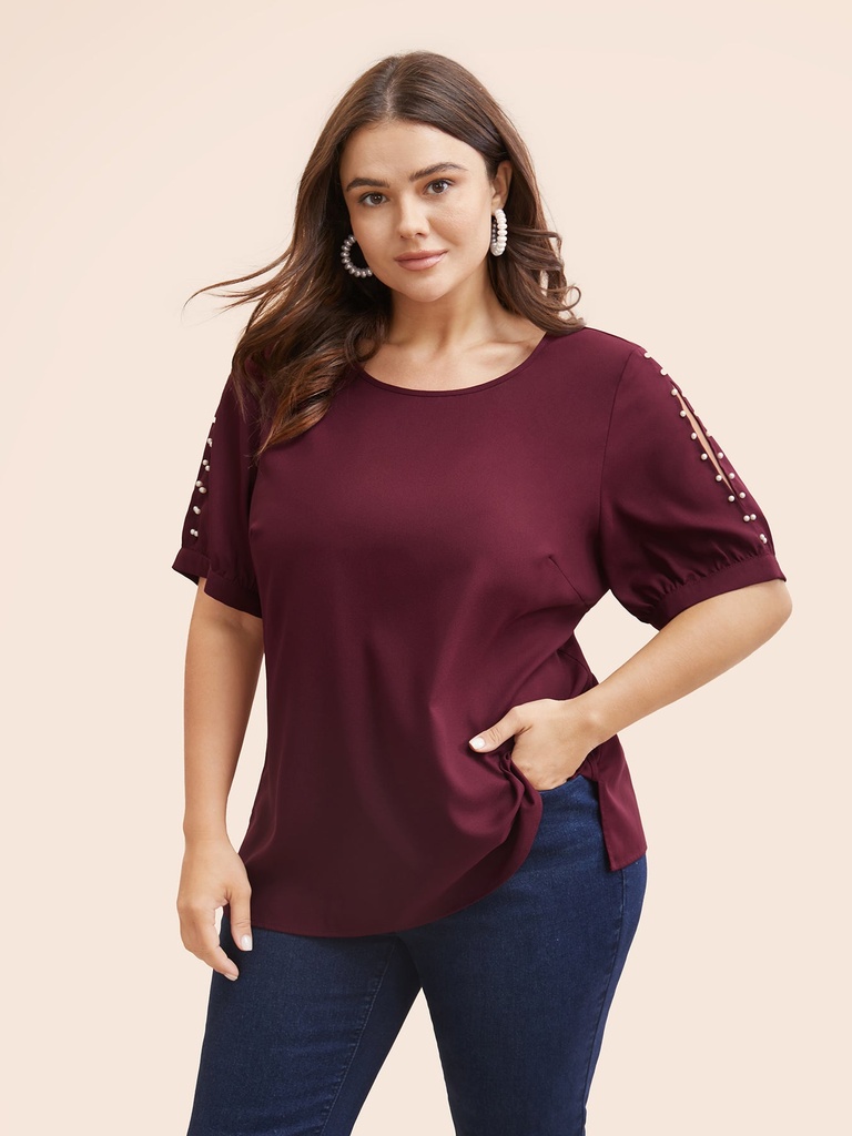 Blusa con mangas abiertas y perlas